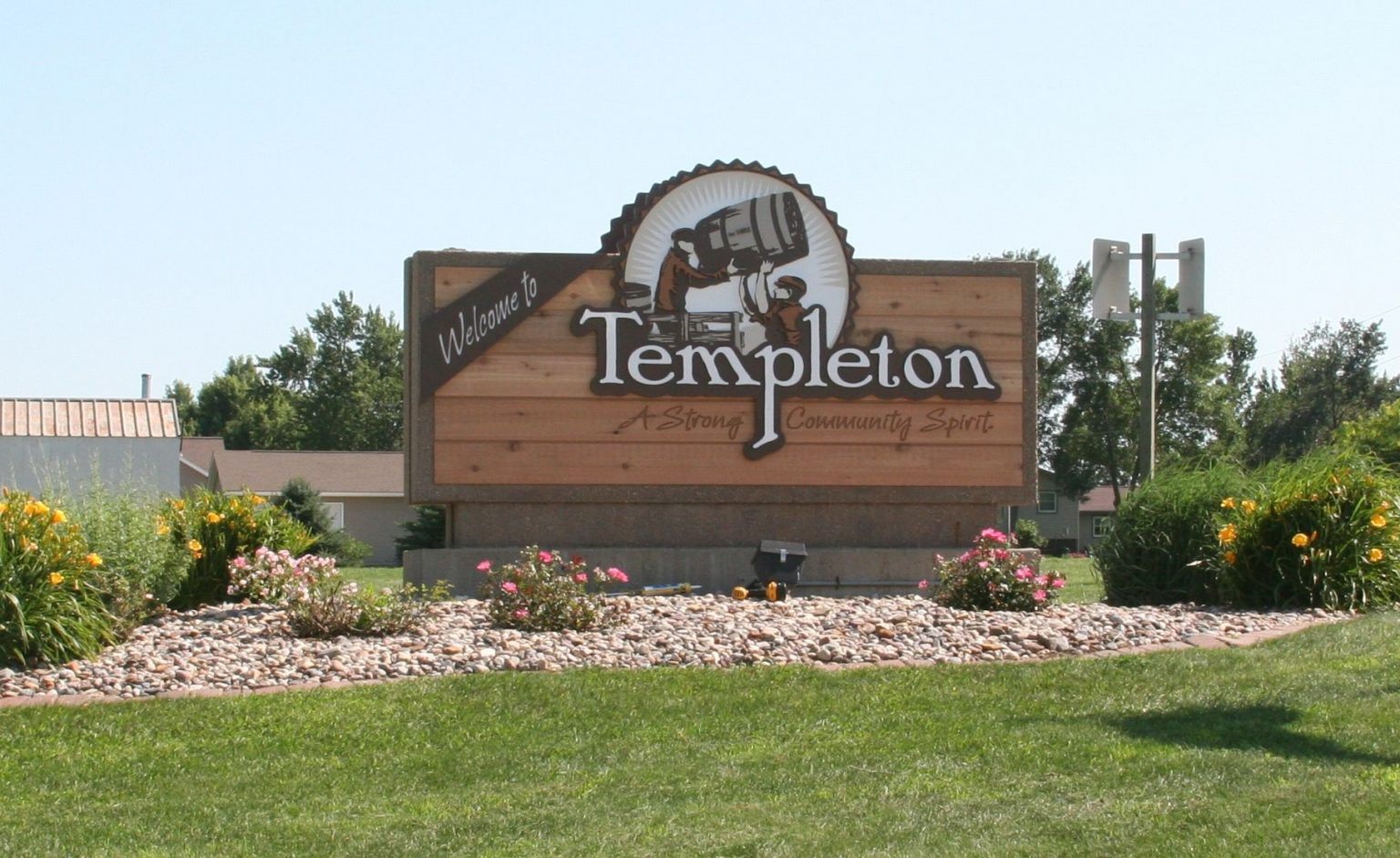 The Welcome to Templeton sign at the edge of town, reading A Strong Community Spirit.